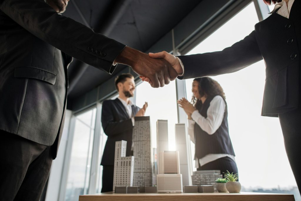 Selective focus on hands of two business people handshake after successful deal